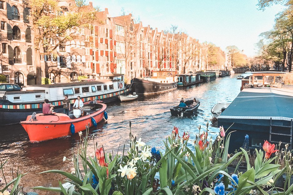 Houseboats and flowers along a canal in Amsterdam, The Netherlands