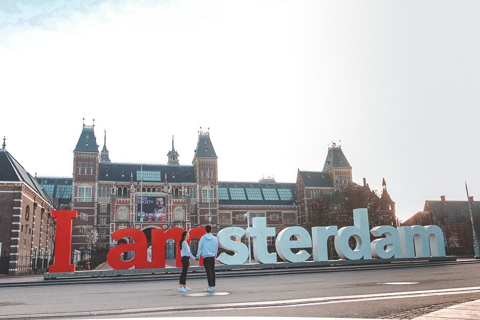 Standing in front of the Iamsterdam sign at dawn, Amsterdam