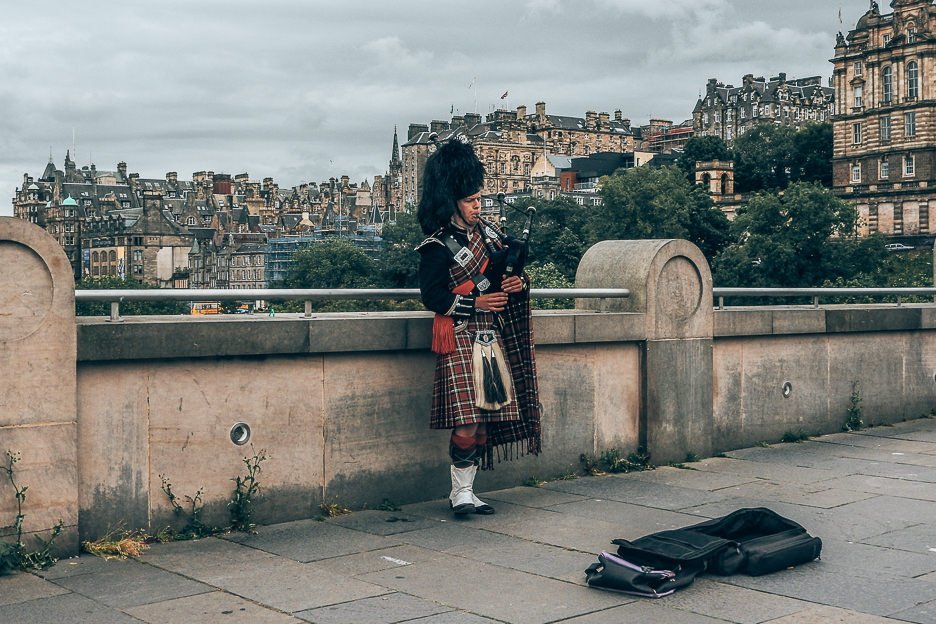 A man in traditional Scottish dress plays the bagpipes, Edinburgh, Scotland