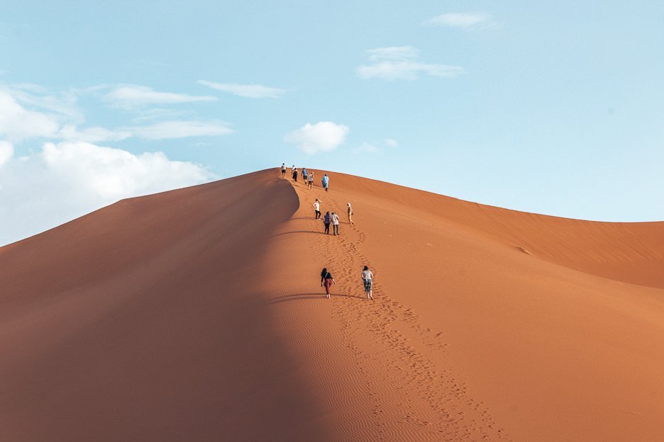 Climbing sand dunes in the Sahara Desert, Morocco