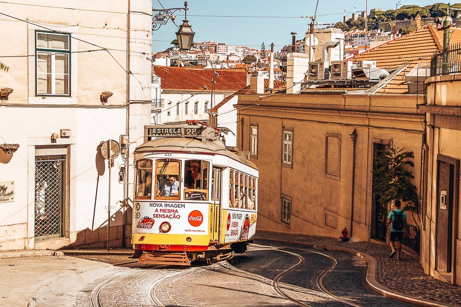 Yellow tram 28 rumbling up the hill - Lisbon, Portugal