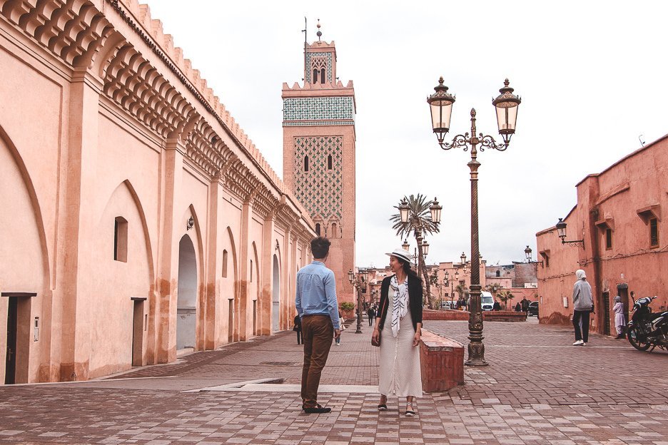 Jasmine and Bevan of The Travel Quandary stand outside Katoubia Mosque, Marrakech Morocco