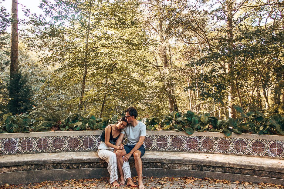 A couple sit on a beautiful mosaic bench in the gardens of Pena Palace, Sintra