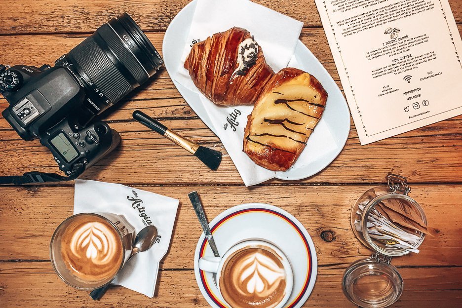 A flatlay of two flat whites and sweet pastries at Ditta Artigianale in Florence, Italy - a cafe for the best coffee in Europe