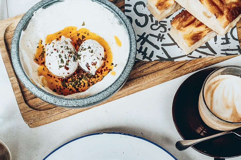Poached eggs with chilli oil, pitta bread and coffee - Brunch in London