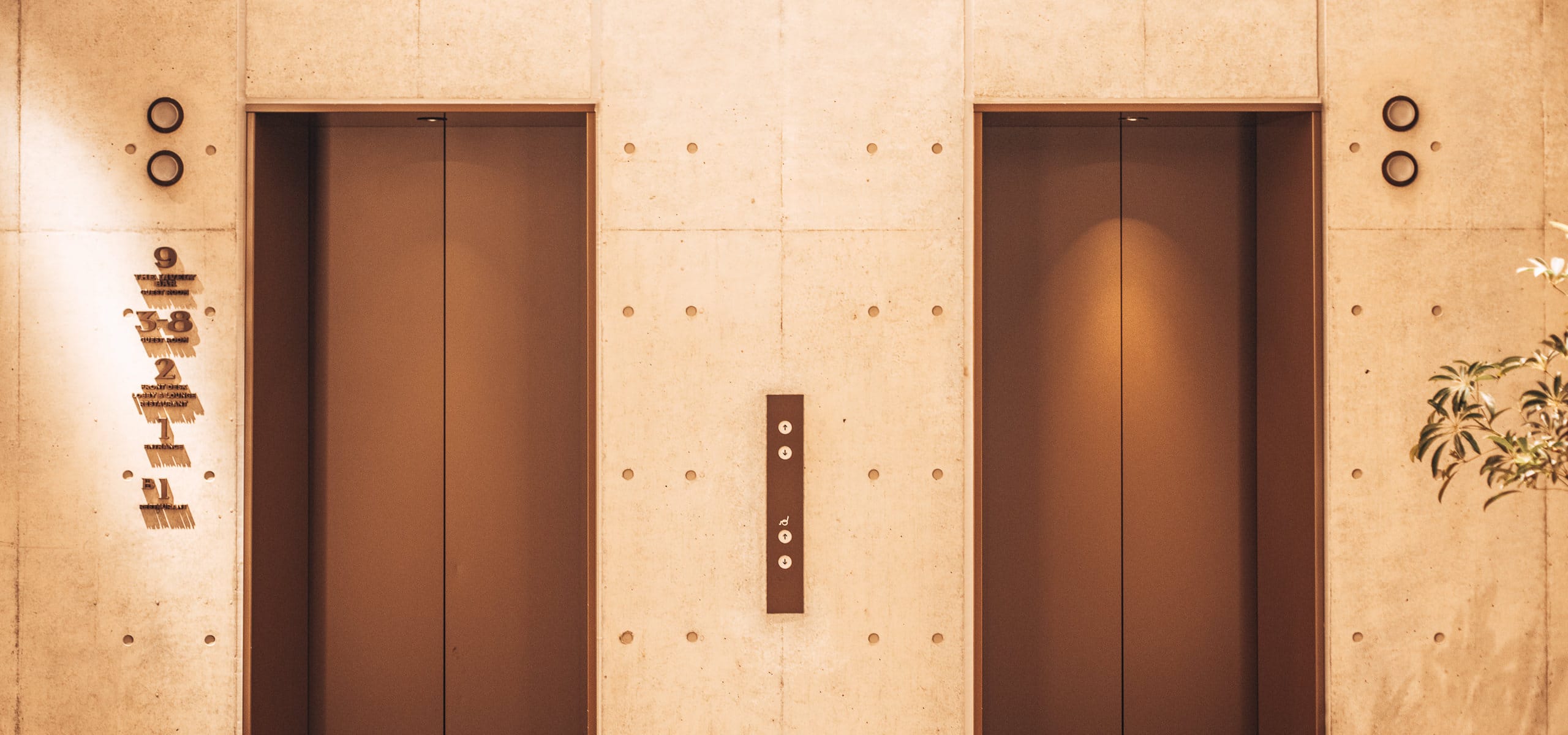 The brass elevator doors at reception at The Lively Azabujuban - Minato City Tokyo