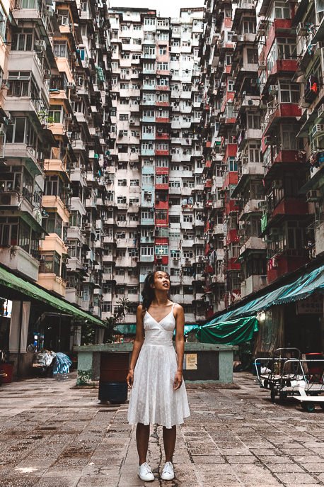 A girl stands in the courtyard of Yick Fat Building Hong Kong