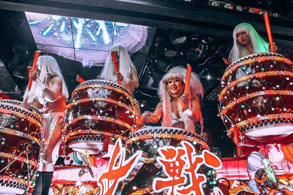 Four ladies in long white wigs bang drums at the Robot Restaurant | Shinjuku what to see