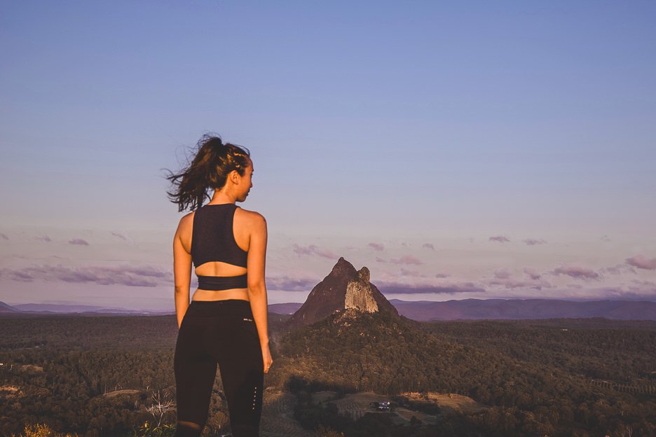 Jasmine stands atop Mount Ngungun in the Glass House Mountains - places near Brisbane