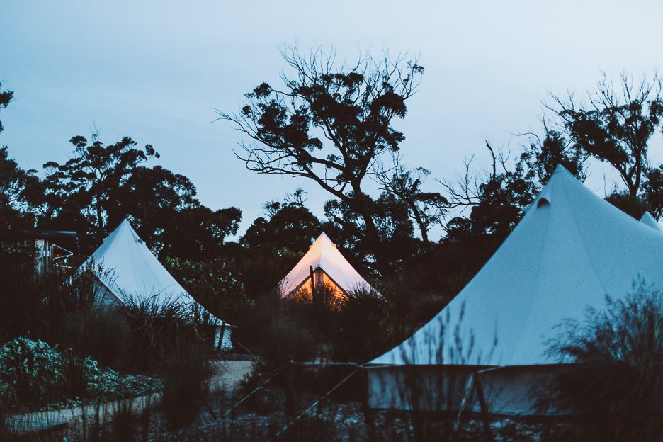 Bell tents at dusk at Bay of Fires Bush Retreat, Binalong Bay Tasmania